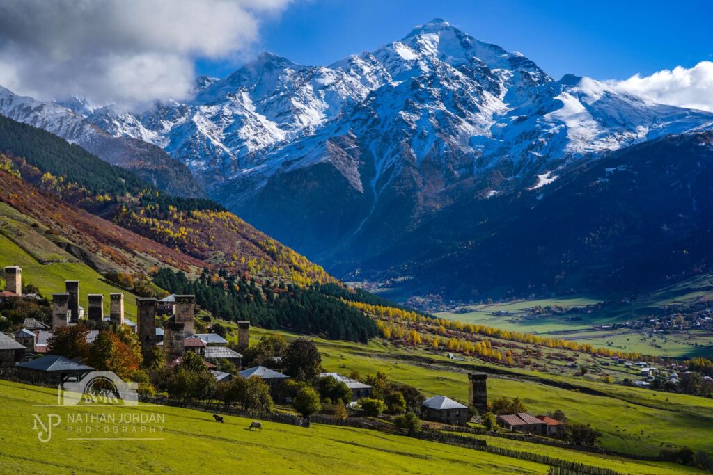 Lakhiri village towers in sunny weather beneath snowy mountains nathan jordan photography